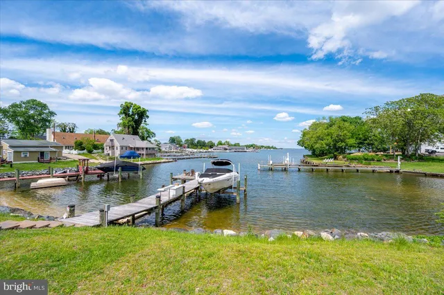 an aerial view of a house with a yard and lake view