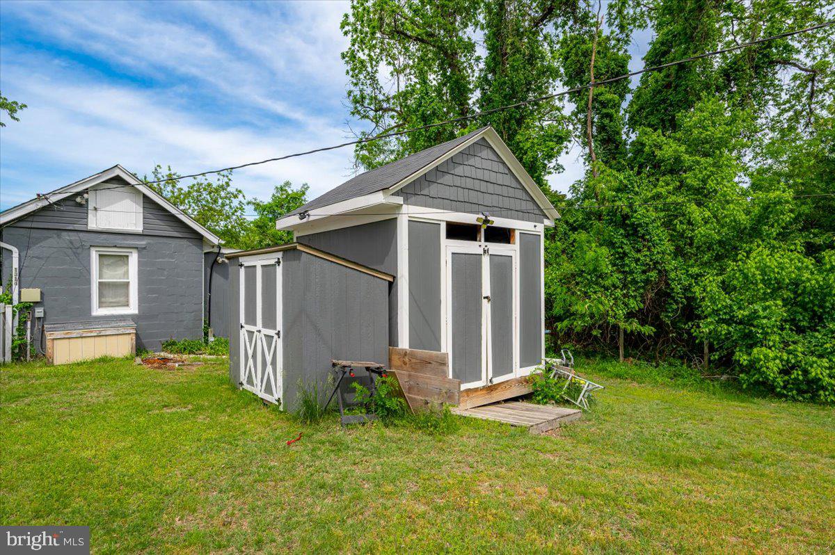 1312 Tuggies Road Pasadena, MD 21122 - Photo 49 of 75 a view of a yard in front of a house with plants and large tree