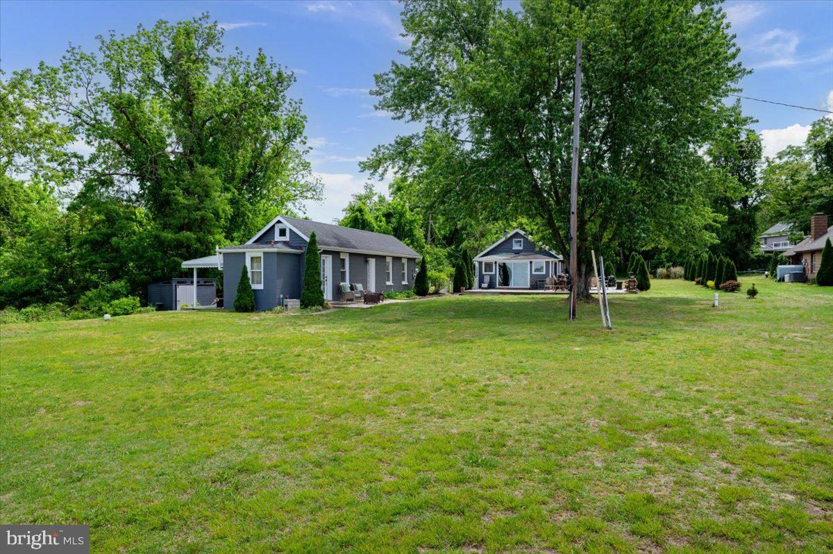 1312 Tuggies Road Pasadena, MD 21122 - Photo 50 of 75 a front view of a house with garden