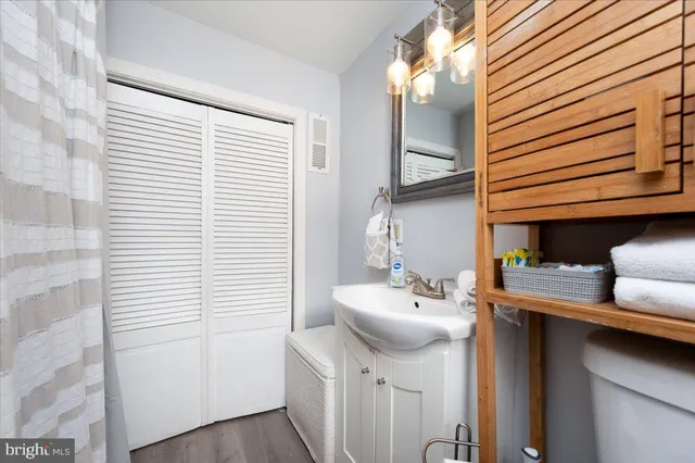 a bedroom with a bed a dresser and a window