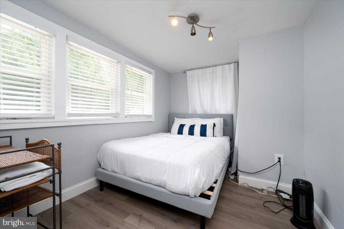 1312 Tuggies Road Pasadena, MD 21122 - Photo 6 of 75 a bedroom with a bed a dresser and a window