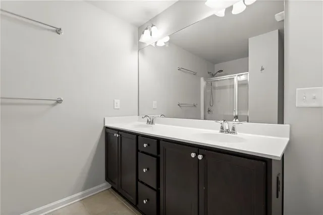 a bathroom with a double vanity sink and a mirror