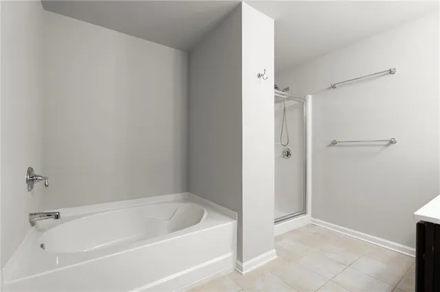 a white bath tub sitting next to a shower