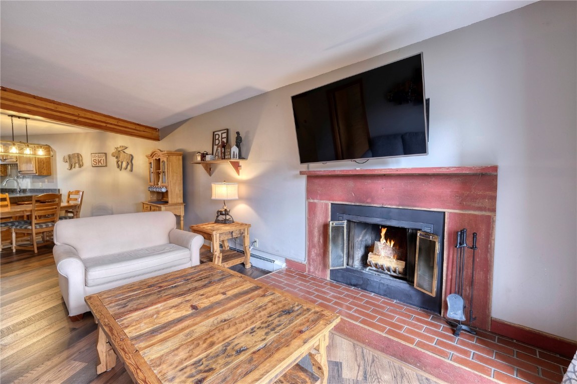 94300 Ryan Gulch Road, Unit 94302 Silverthorne, CO 80498 - Photo 11 of 33 a bedroom with a bed and a fireplace