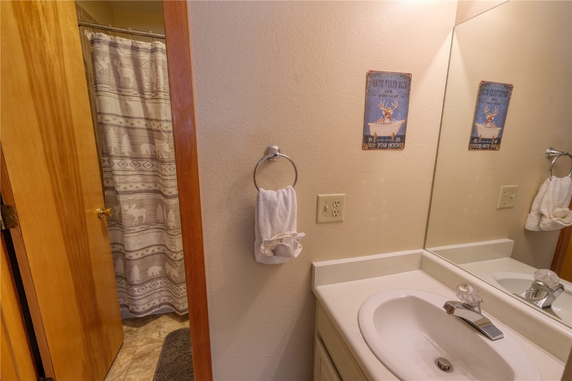 94300 Ryan Gulch Road, Unit 94302 Silverthorne, CO 80498 - Photo 15 of 33 a bathroom with a sink and mirror