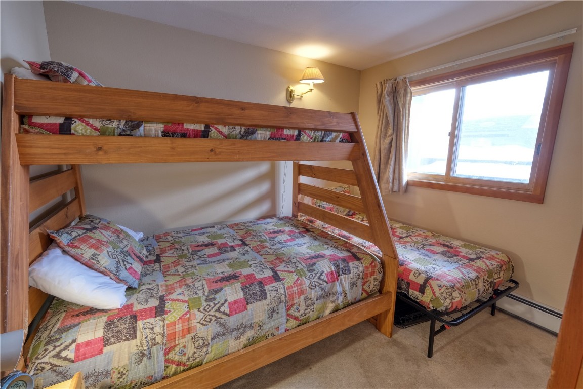 94300 Ryan Gulch Road, Unit 94302 Silverthorne, CO 80498 - Photo 17 of 33 a bedroom with a bed and a window