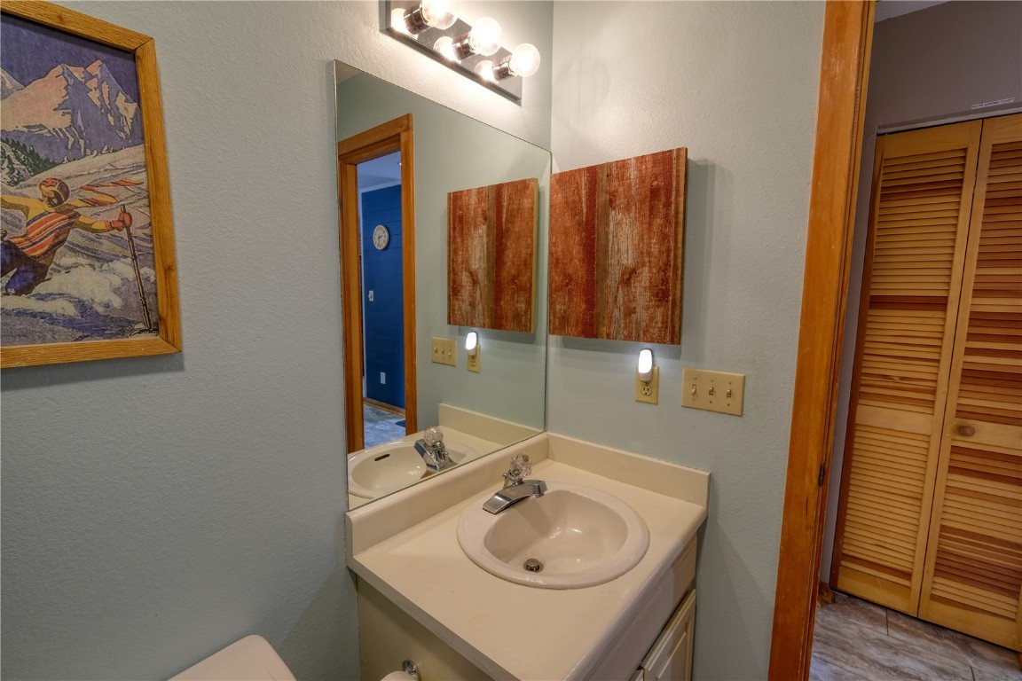94300 Ryan Gulch Road, Unit 94302 Silverthorne, CO 80498 - Photo 20 of 33 a bathroom with a sink and a mirror