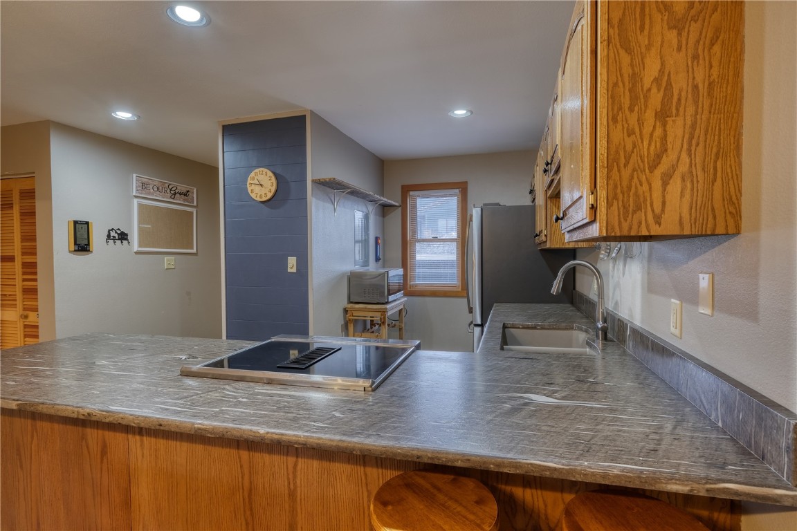94300 Ryan Gulch Road, Unit 94302 Silverthorne, CO 80498 - Photo 2 of 33 a kitchen with stainless steel appliances granite countertop a sink and a counter top space