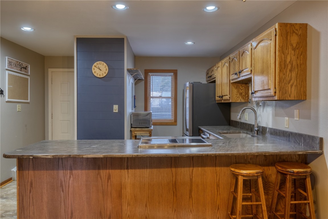 94300 Ryan Gulch Road, Unit 94302 Silverthorne, CO 80498 - Photo 3 of 33 a kitchen with stainless steel appliances granite countertop a sink a stove counter space and cabinets