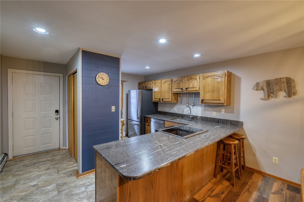 94300 Ryan Gulch Road, Unit 94302 Silverthorne, CO 80498 - Photo 4 of 33 a kitchen with stainless steel appliances granite countertop a sink a stove and a refrigerator