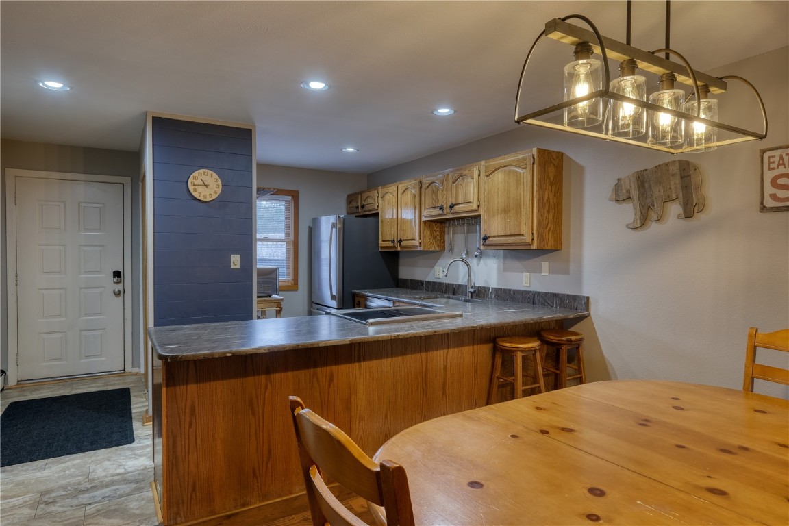 94300 Ryan Gulch Road, Unit 94302 Silverthorne, CO 80498 - Photo 5 of 33 a kitchen with a sink appliances and cabinets