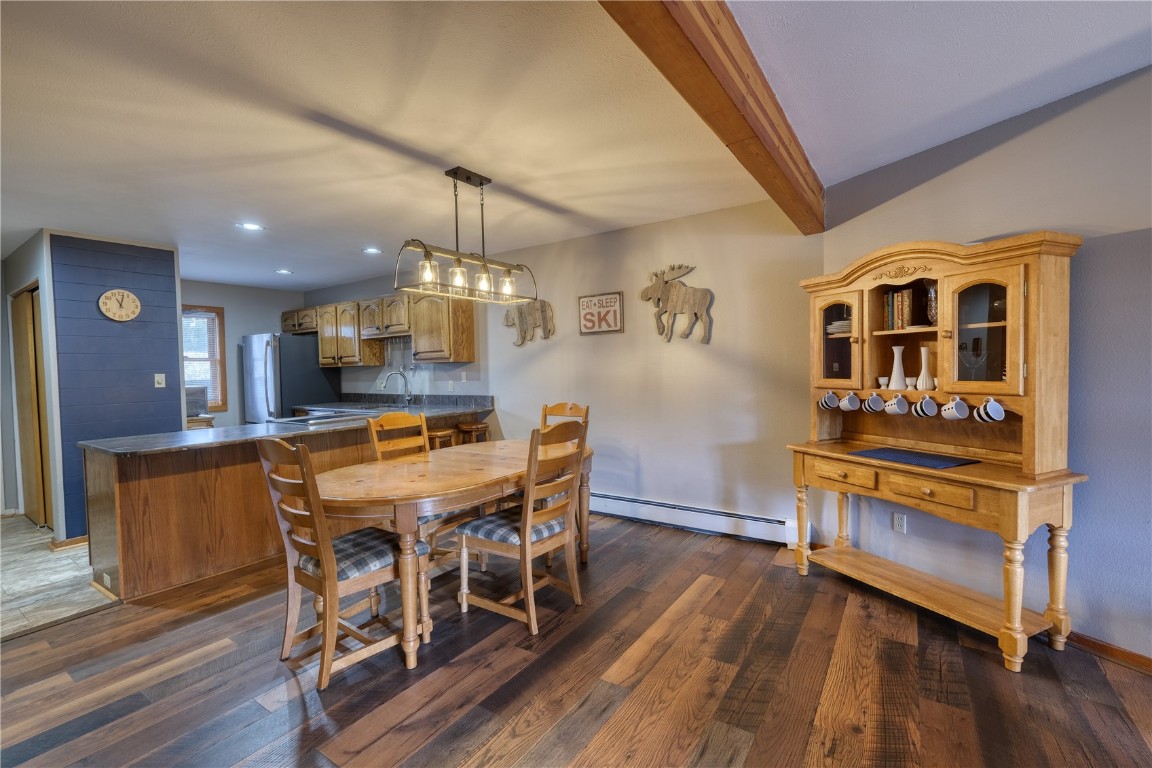 94300 Ryan Gulch Road, Unit 94302 Silverthorne, CO 80498 - Photo 6 of 33 a view of a dining room with furniture and wooden floor