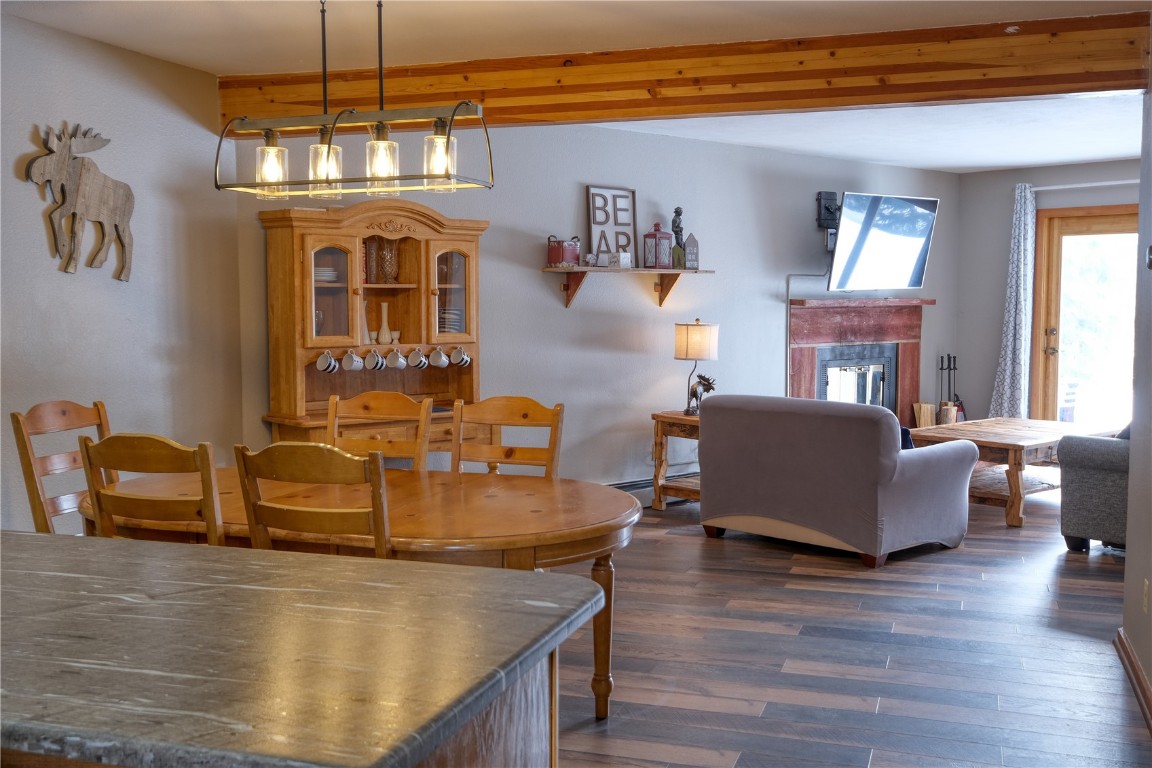 94300 Ryan Gulch Road, Unit 94302 Silverthorne, CO 80498 - Photo 7 of 33 a living room with furniture and a chandelier