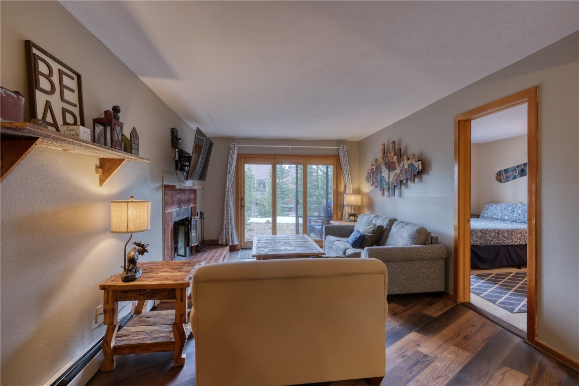 94300 Ryan Gulch Road, Unit 94302 Silverthorne, CO 80498 - Photo 9 of 33 a living room with furniture and a fireplace