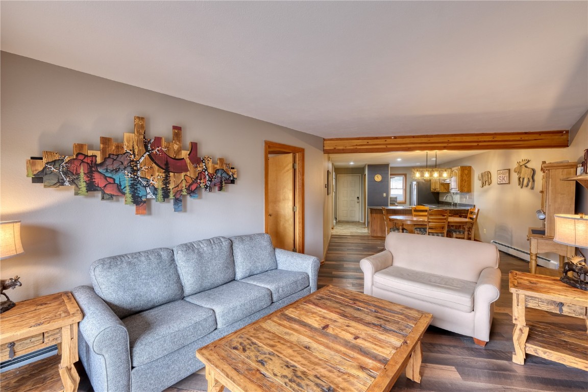 94300 Ryan Gulch Road, Unit 94302 Silverthorne, CO 80498 - Photo 10 of 33 a living room with furniture and a large window
