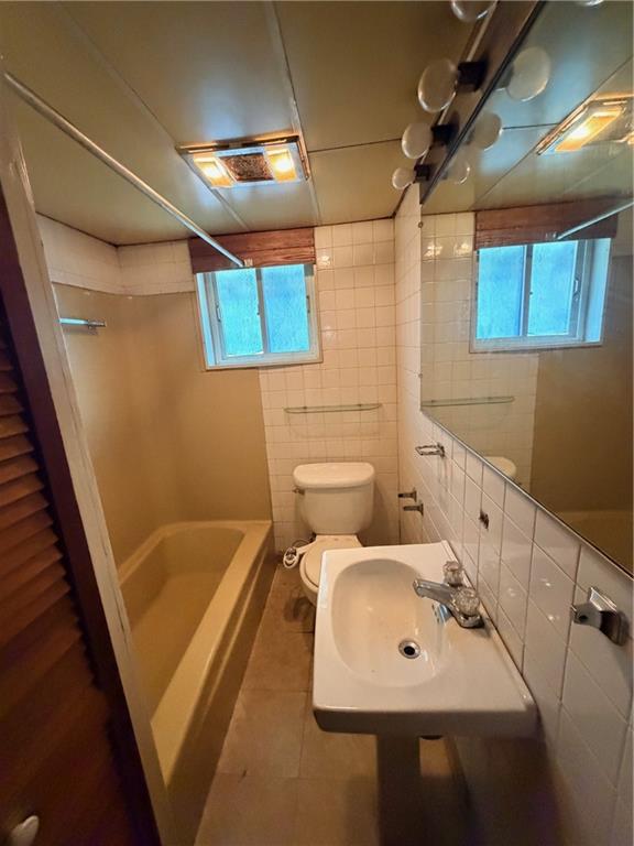 408 Simms Street Pittsburgh, PA 15211 - Photo 7 of 15 a bathroom with a sink mirror and a bathtub