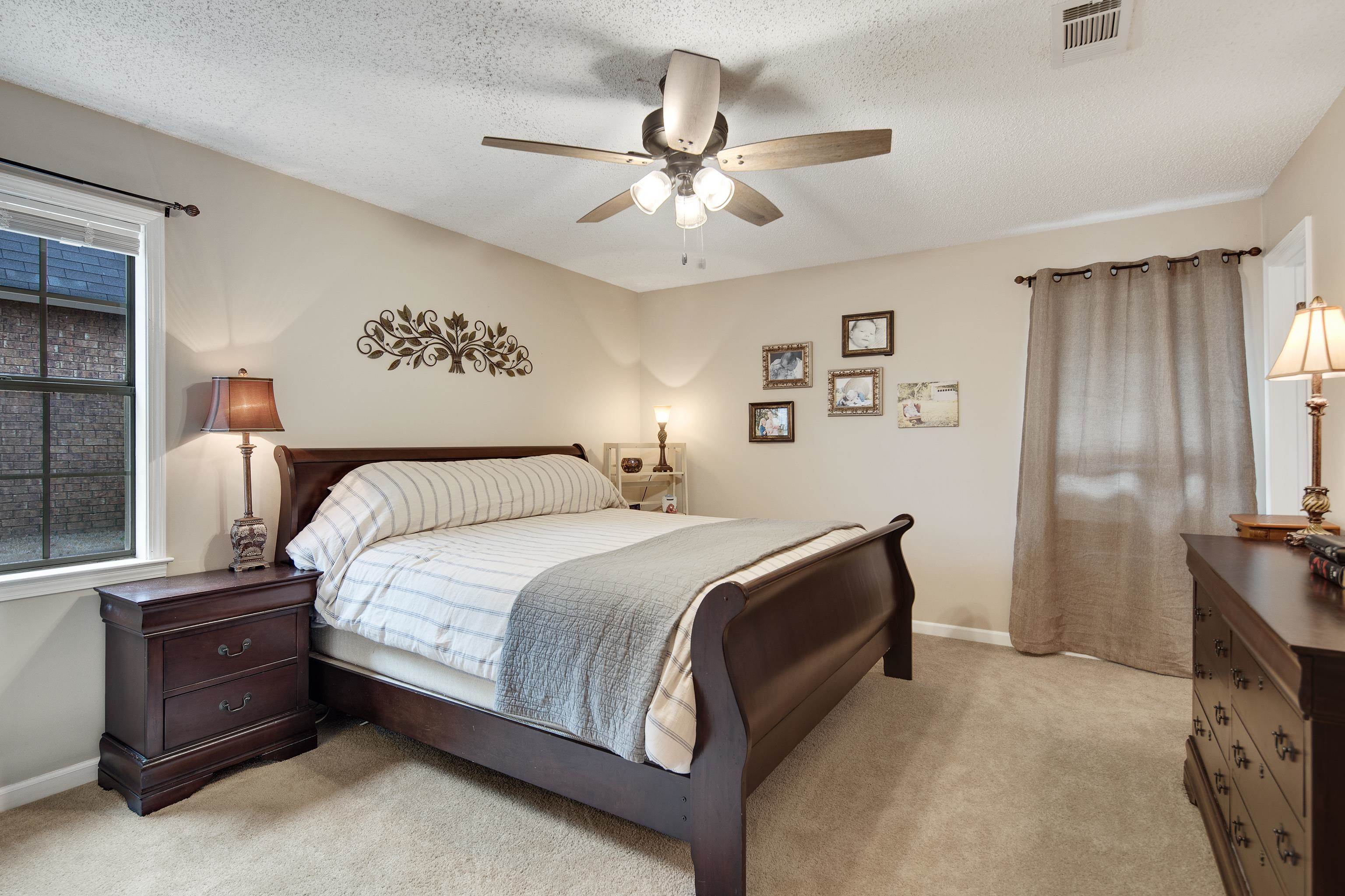 411 Shelton Road Collierville, TN 38017 - Photo 11 of 19 a bedroom with a bed and a ceiling fan