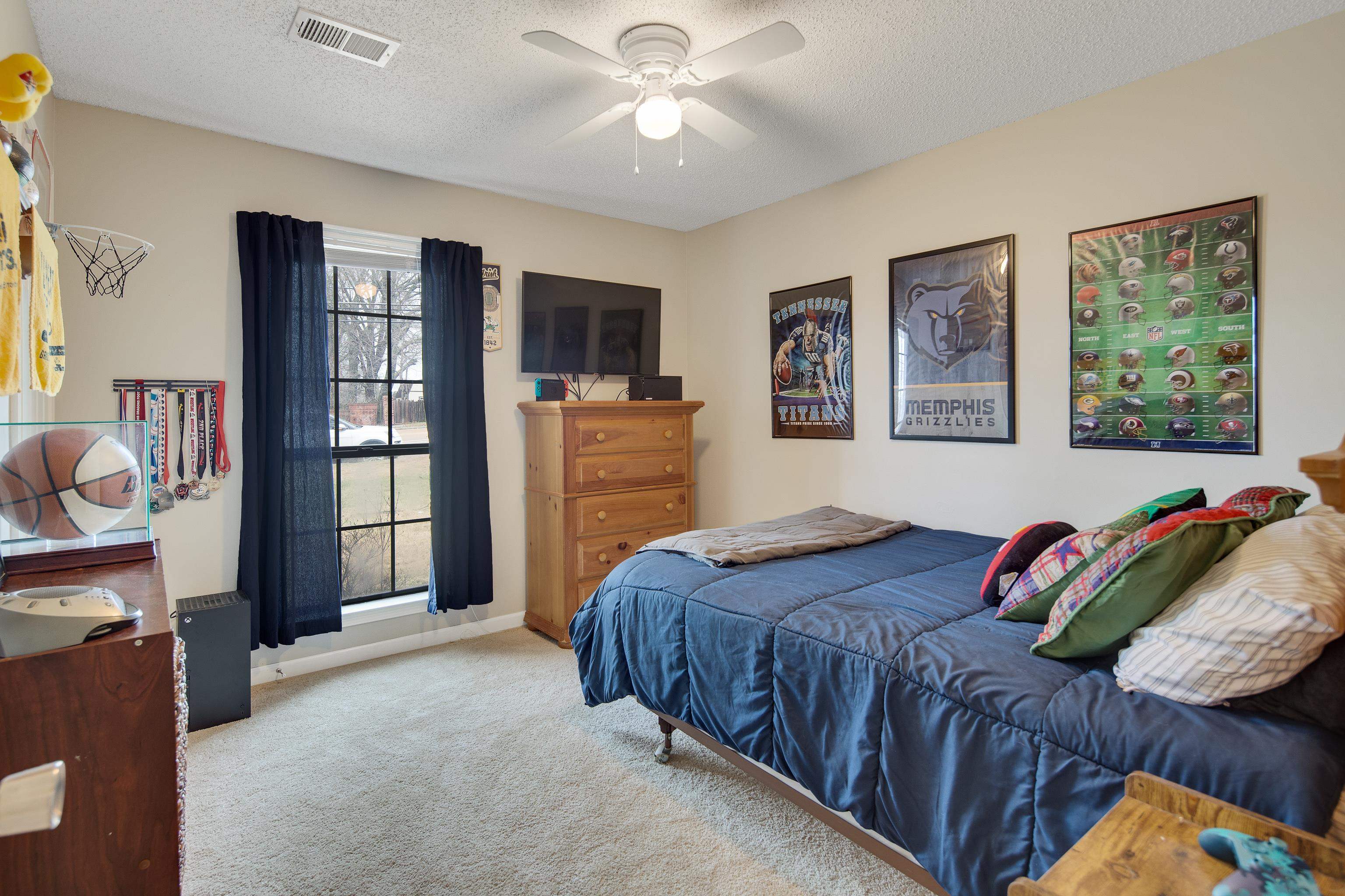411 Shelton Road Collierville, TN 38017 - Photo 13 of 19 a bedroom with a bed and a chandelier