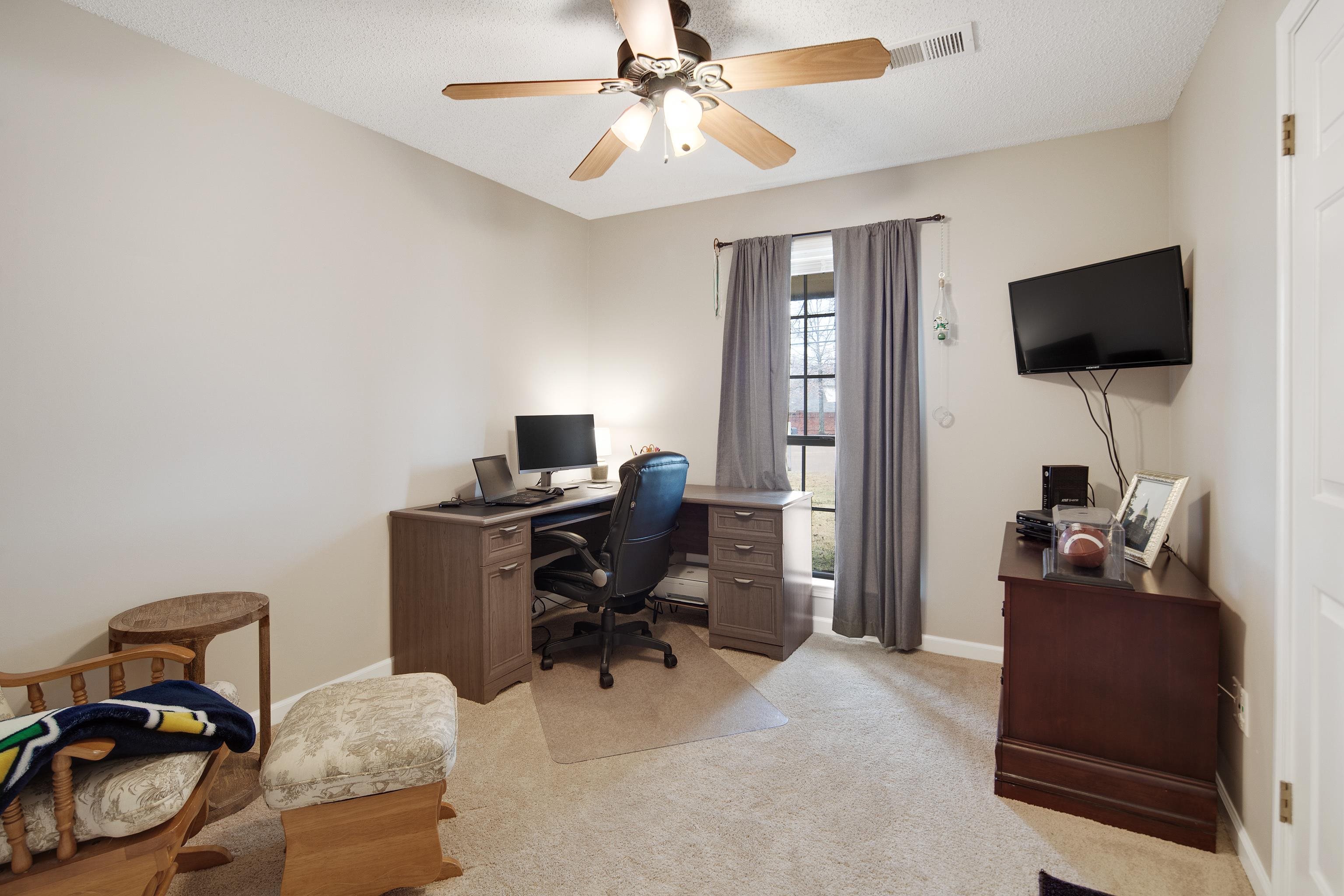 411 Shelton Road Collierville, TN 38017 - Photo 14 of 19 a view of a workspace with furniture and a window