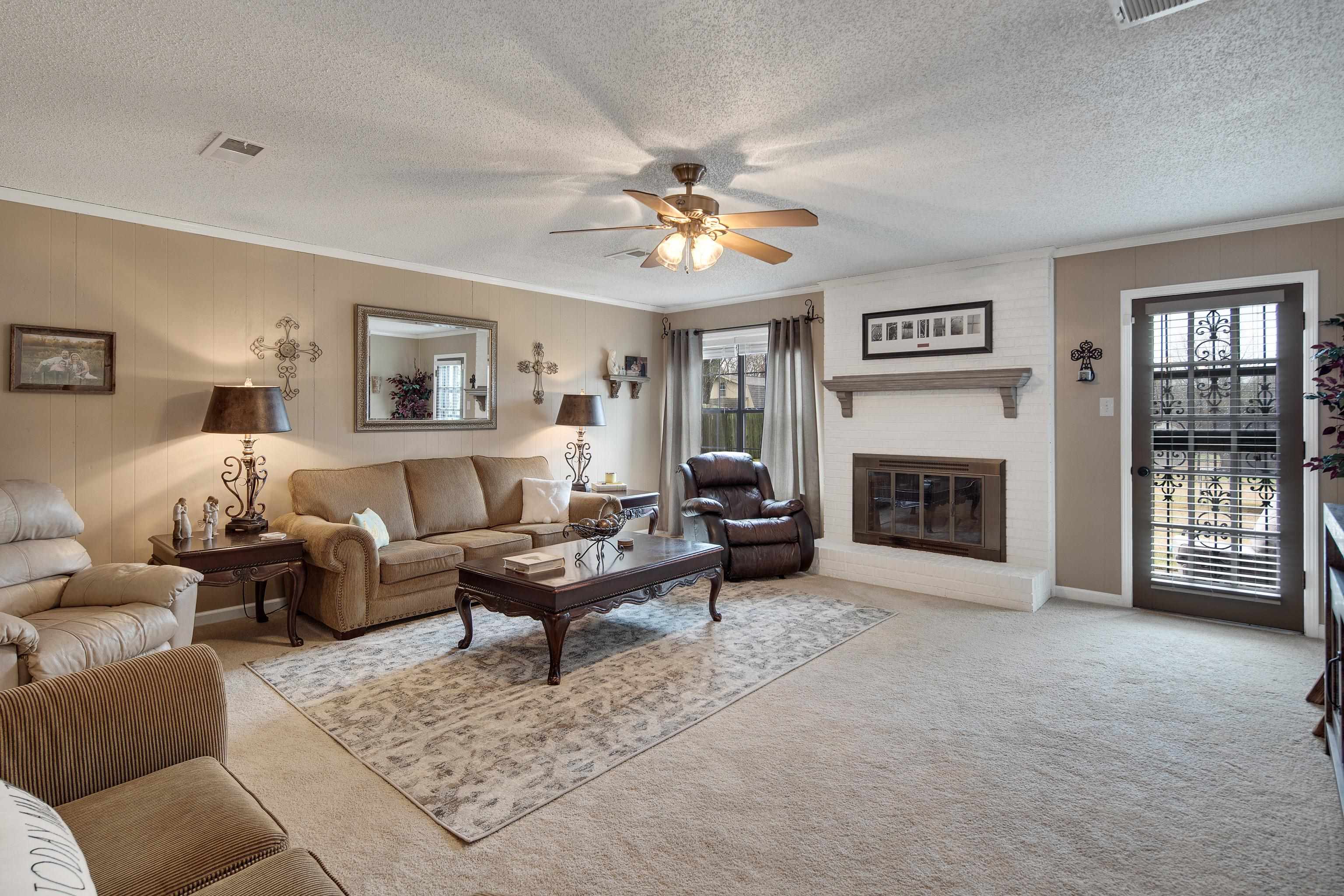 411 Shelton Road Collierville, TN 38017 - Photo 4 of 19 a living room with furniture a fireplace and a flat screen tv