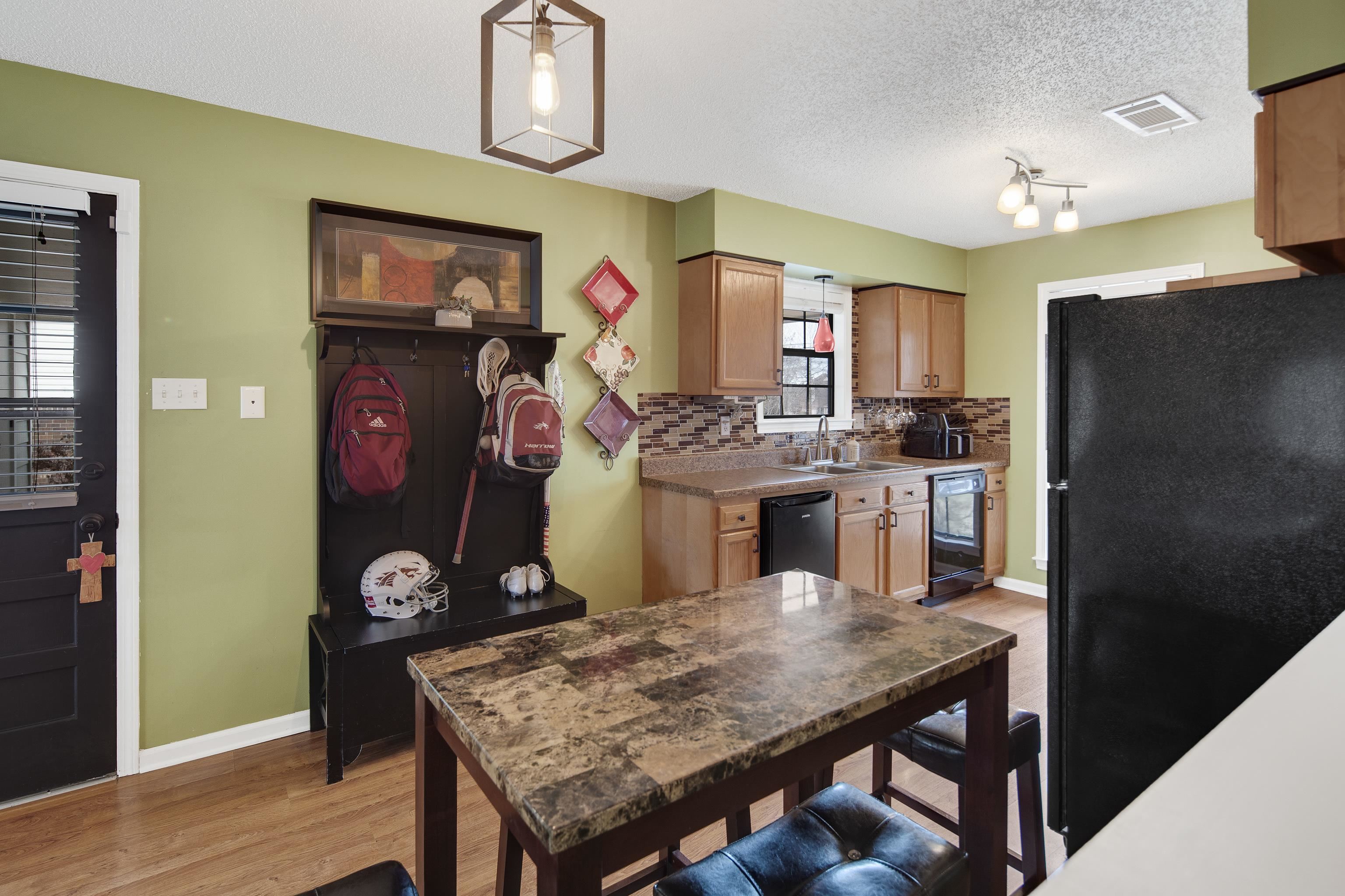 411 Shelton Road Collierville, TN 38017 - Photo 9 of 19 a kitchen with stainless steel appliances granite countertop wooden floor and refrigerator