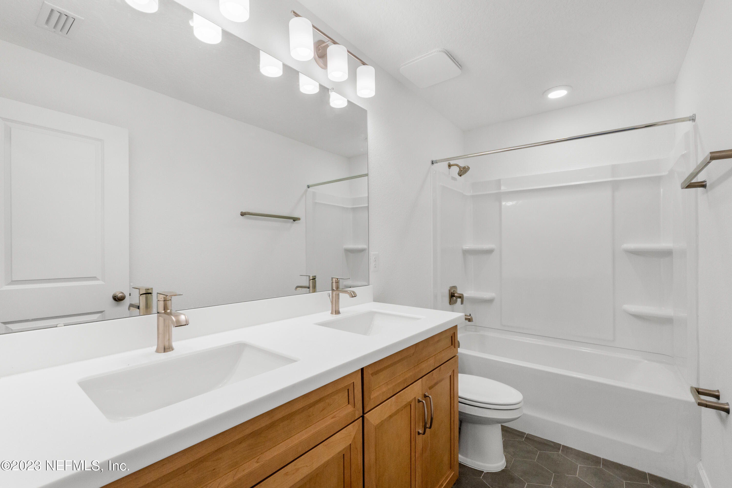 25 Shipman Court St. Augustine, FL 32092 - Photo 11 of 12 a bathroom with a sink a toilet and shower