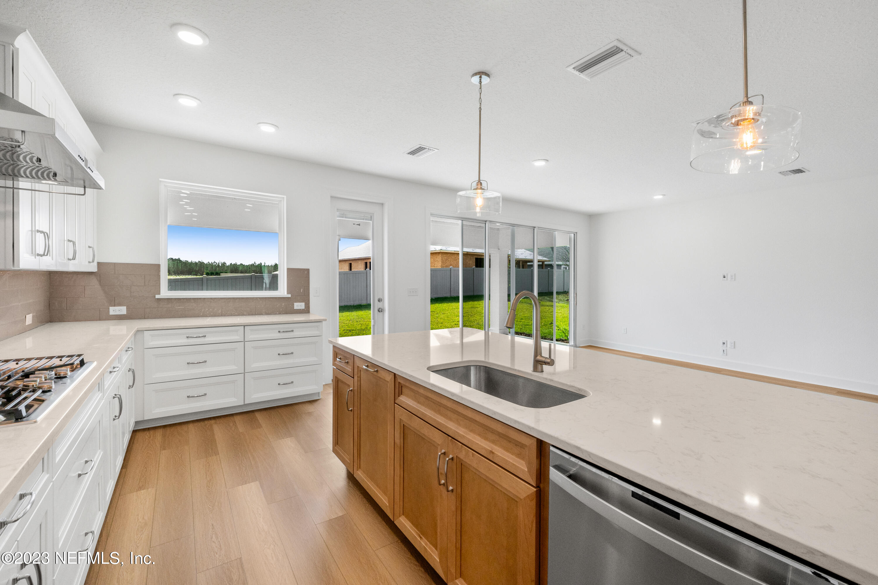 25 Shipman Court St. Augustine, FL 32092 - Photo 3 of 12 a kitchen with stainless steel appliances granite countertop a sink a stove and a wooden floors