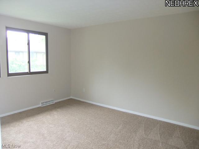 992 Hampton Ridge Drive Akron, OH 44313 - Photo 12 of 17 The master bedroom shows off a light and bright layout with large windows...