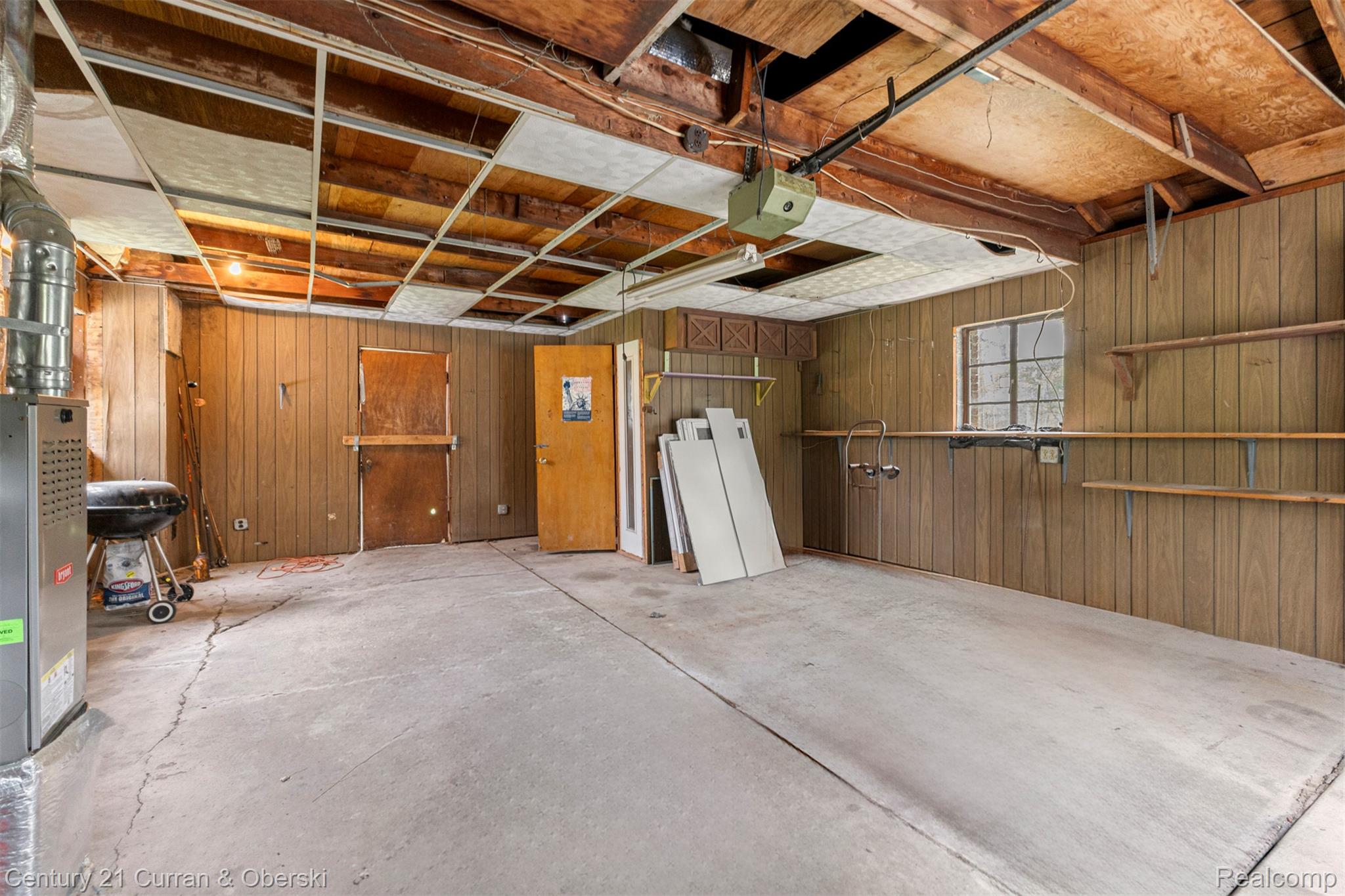 25205 Inkster Road Farmington, MI 48336 - Photo 28 of 46 Garage featuring wooden walls and a garage door opener