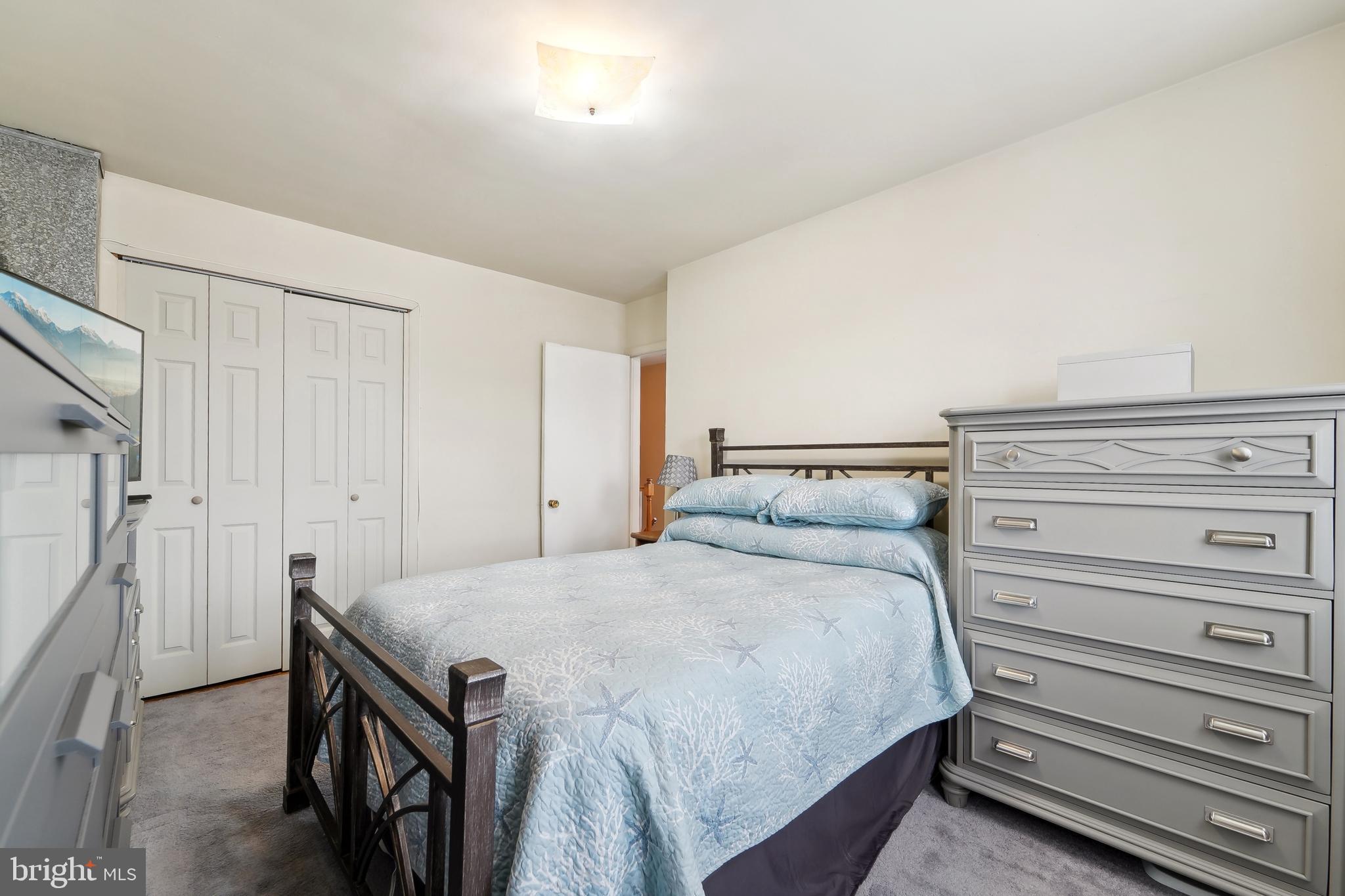 1100 Cedarcroft Road Baltimore, MD 21239 - Photo 19 of 34 a bedroom with a bed and a dresser