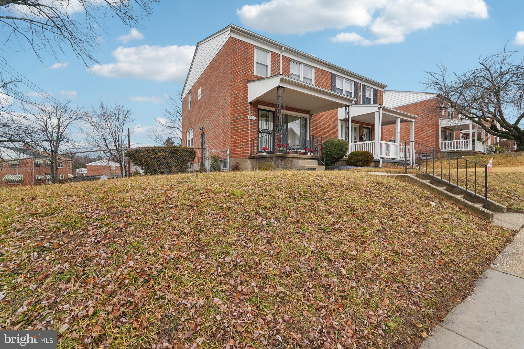1100 Cedarcroft Road Baltimore, MD 21239 - Photo 2 of 34 a front view of a house with a yard
