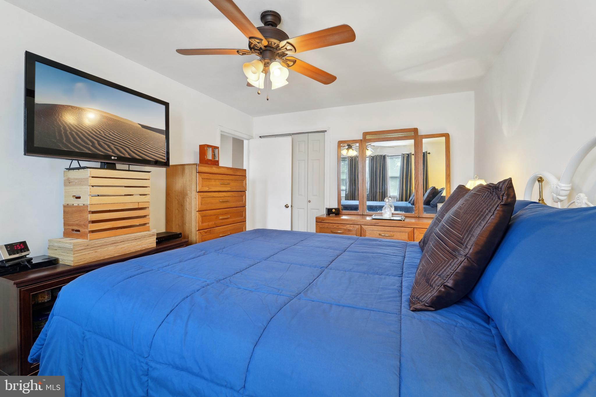 1100 Cedarcroft Road Baltimore, MD 21239 - Photo 21 of 34 a bedroom with a bed and a flat screen tv