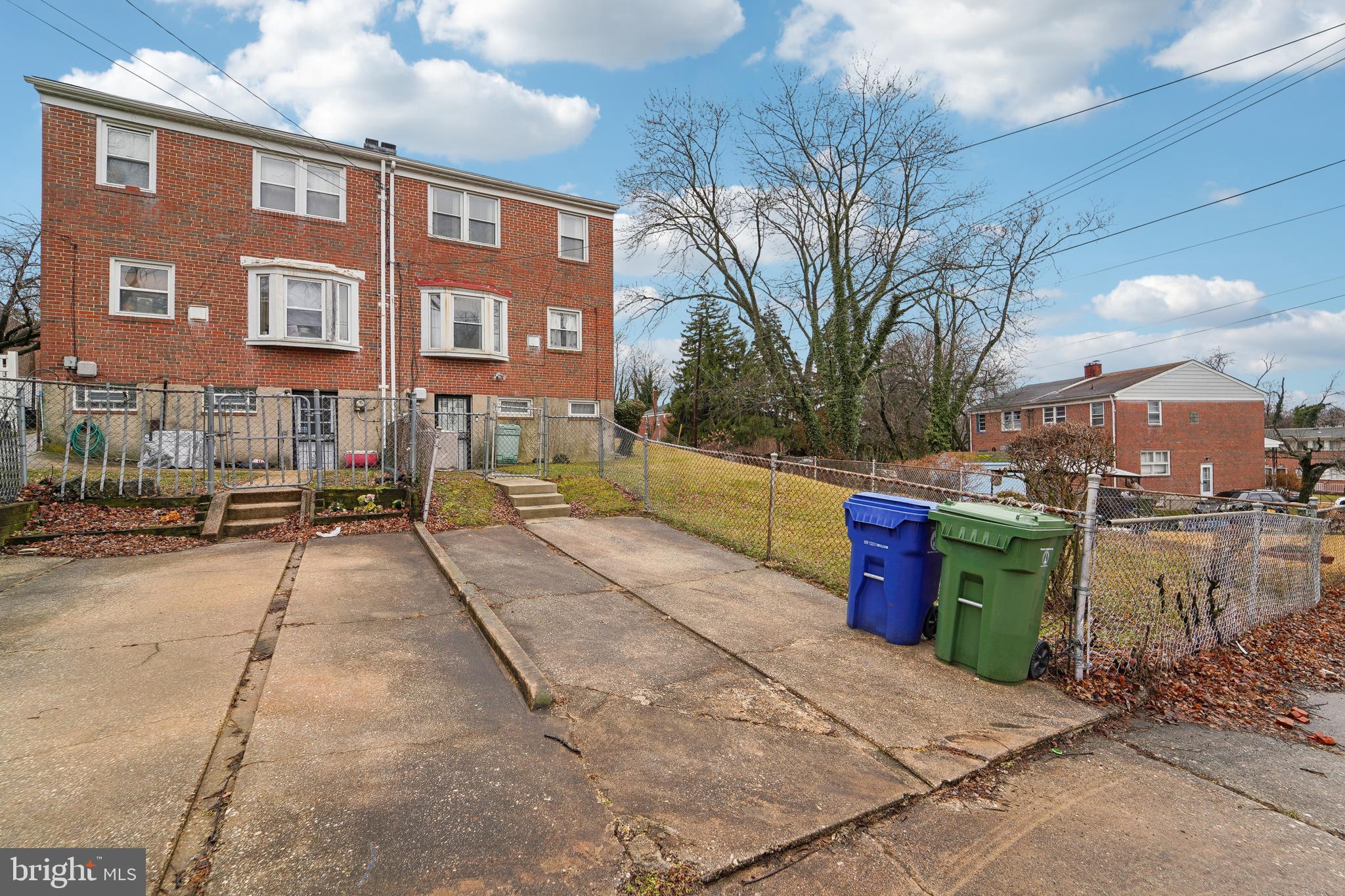 1100 Cedarcroft Road Baltimore, MD 21239 - Photo 26 of 34 a view of a brick house with a yard