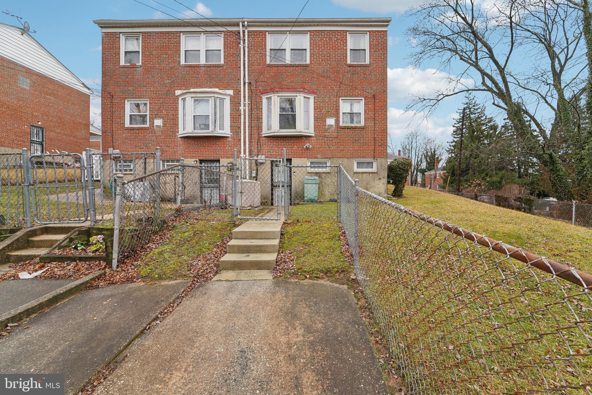 1100 Cedarcroft Road Baltimore, MD 21239 - Photo 29 of 34 a view of a brick building next to a yard