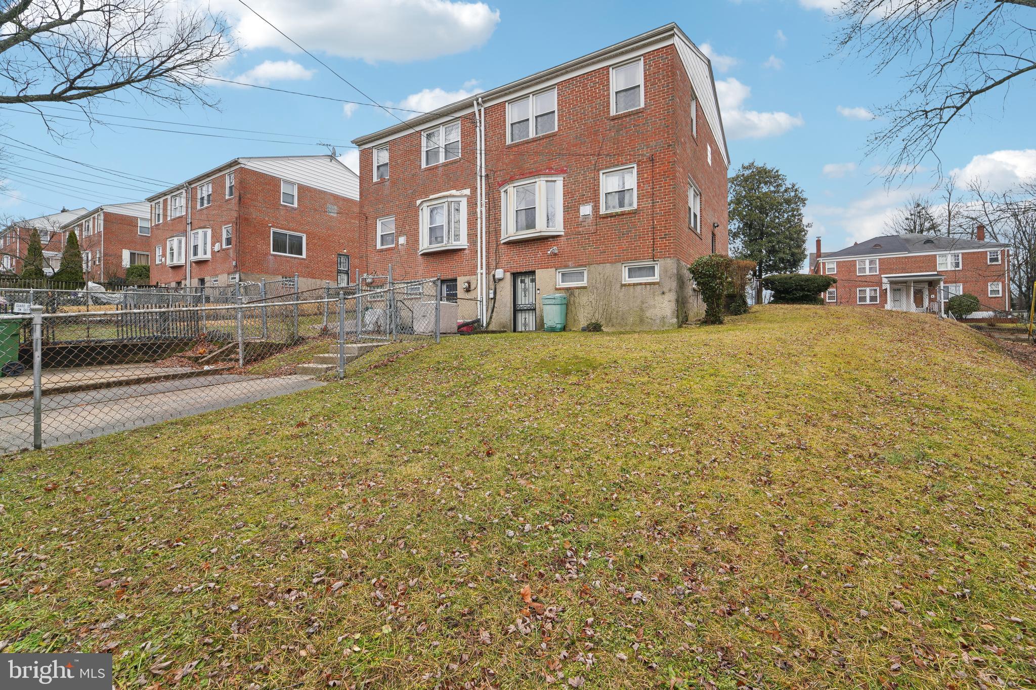 1100 Cedarcroft Road Baltimore, MD 21239 - Photo 30 of 34 a front view of a house with a yard