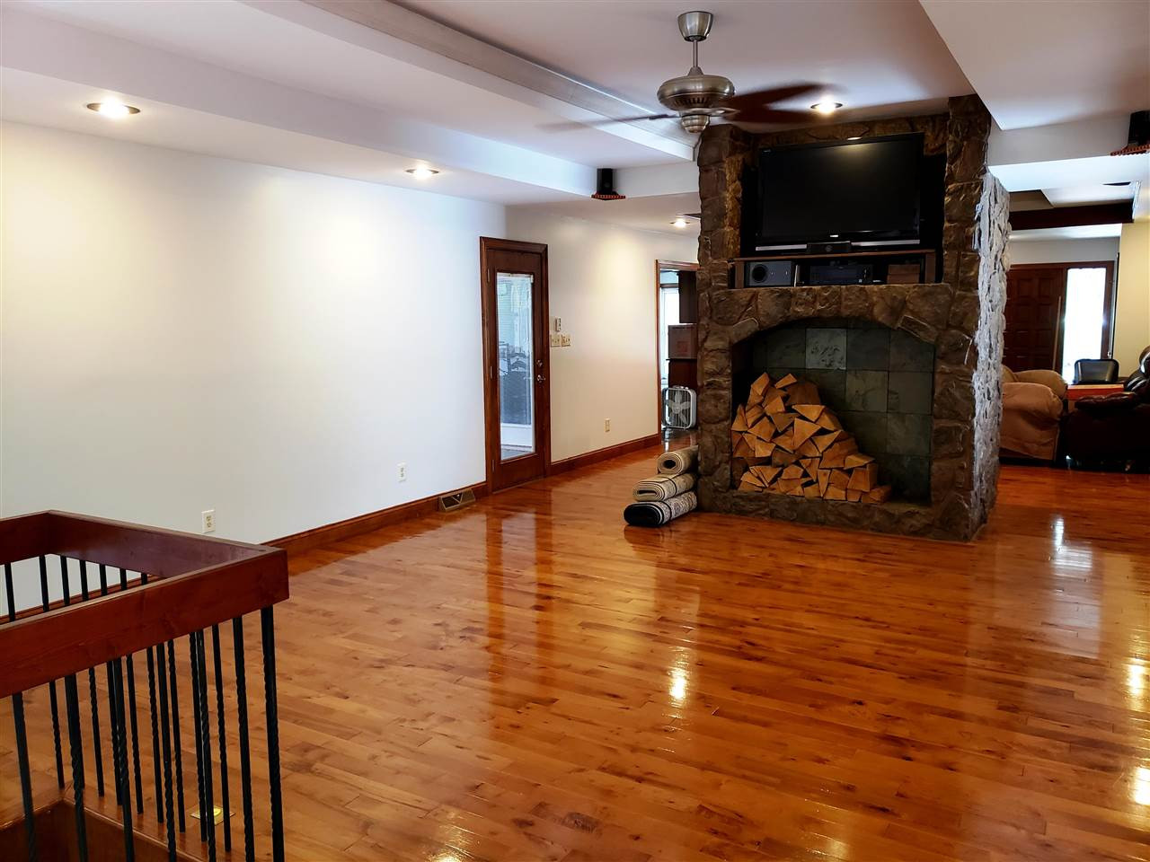 8529 Sawyer Drive Raleigh, NC 27613 - Photo 10 of 28 Den on the other side of the fireplace from living room. 80,000 BT woodstove/FP that ties into the central heating system keeps the house warm all winter. TV, video & sound equipment all convey. Den/Family/Great Room