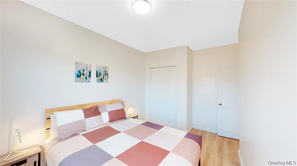 24-12 86th Street, Unit 2 Queens, NY 11369 - Photo 1 of 7 Bedroom featuring light wood-type flooring and a closet