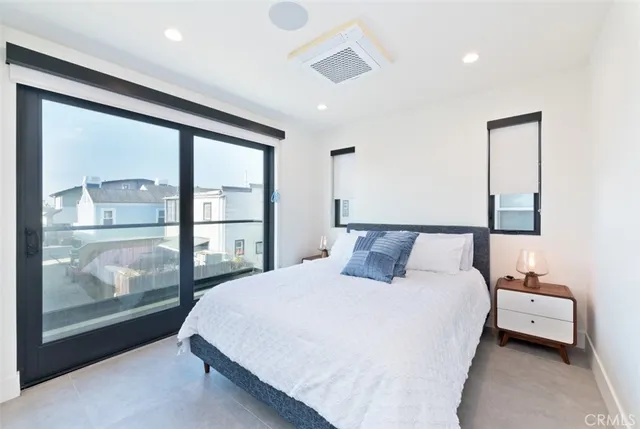 a bedroom with a large bed and a large window