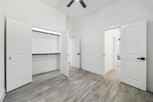 an empty room with wooden floor and window