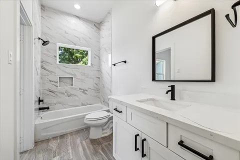a bathroom with a sink a toilet and a bathtub