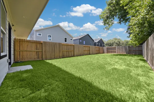 a view of a backyard with a garden and tree