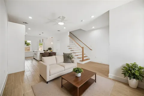 a living room with furniture potted plant and a rug