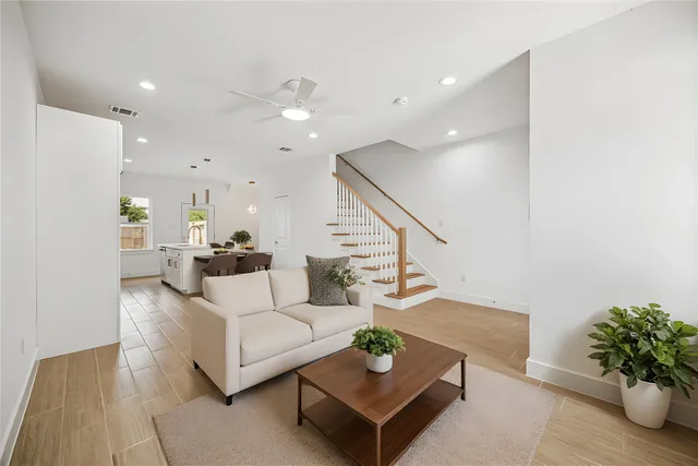 a living room with furniture potted plant and a rug