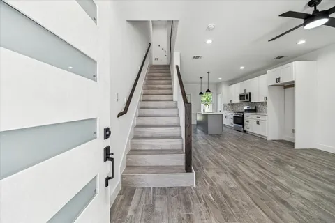 a view of entryway and hall with wooden floor