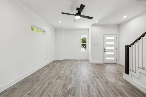 a view of empty room with wooden floor