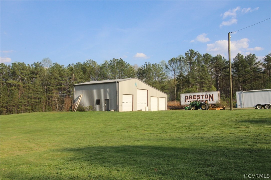 802 Scotts Bottom Road Dillwyn, VA 23936 - Photo 26 of 28 a house that is sitting in the grass with large trees
