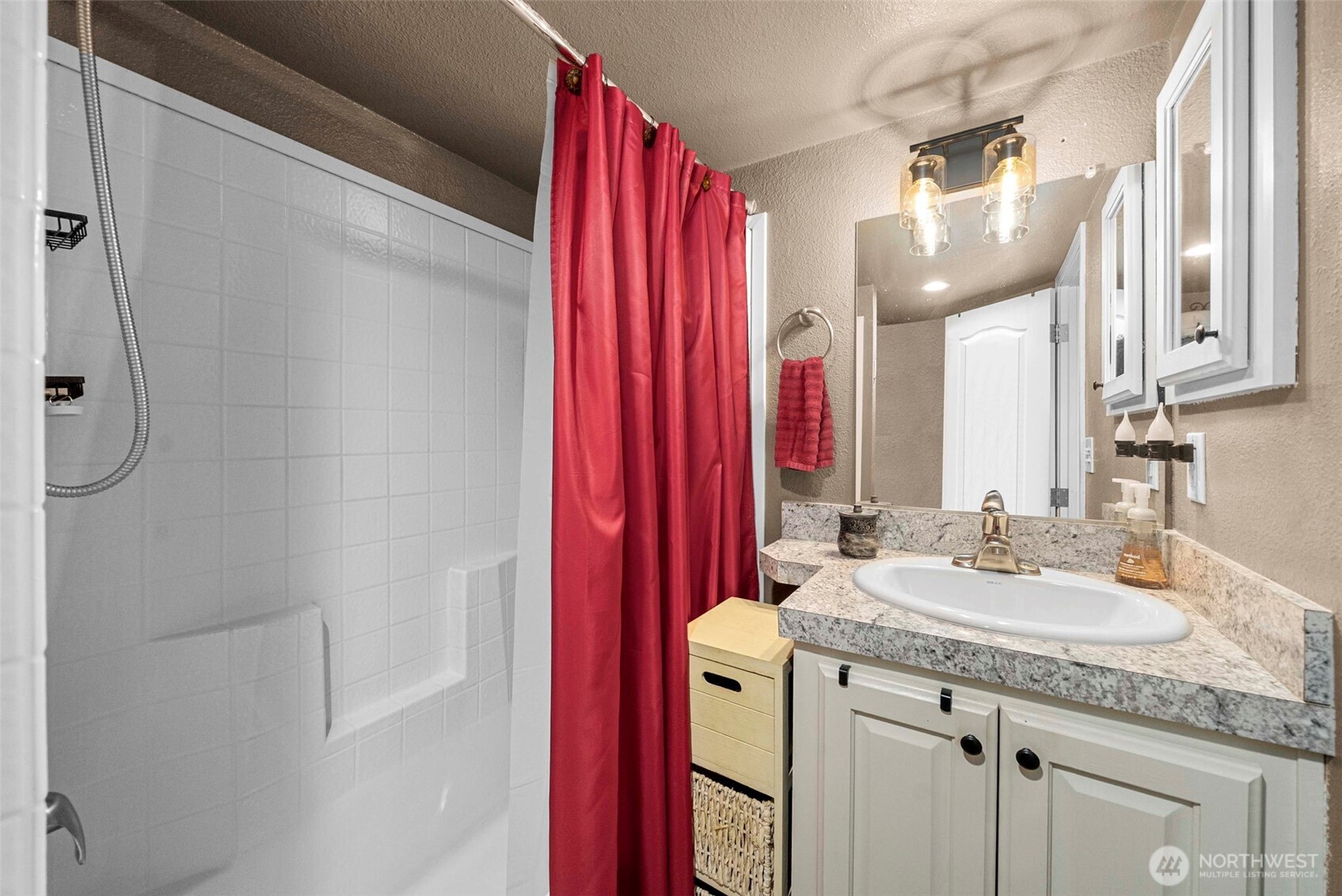 1546 Reservation Road Southeast, Unit 218 Olympia, WA 98513 - Photo 12 of 40 a bathroom with a granite countertop sink and a mirror