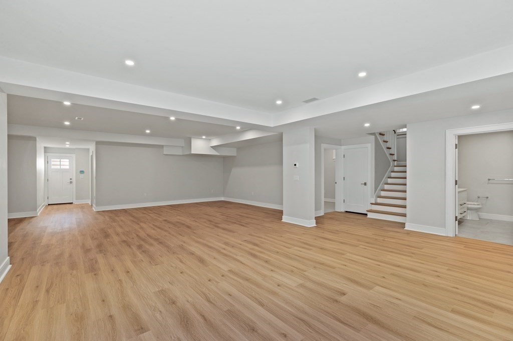 12 Owaisa Road Newton, MA 02468 - Photo 28 of 33 a view of an empty room with wooden floor and a kitchen