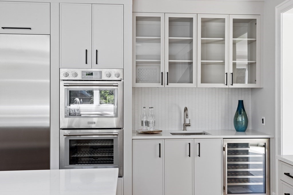 12 Owaisa Road Newton, MA 02468 - Photo 8 of 33 a kitchen with stainless steel appliances white cabinets and a refrigerator