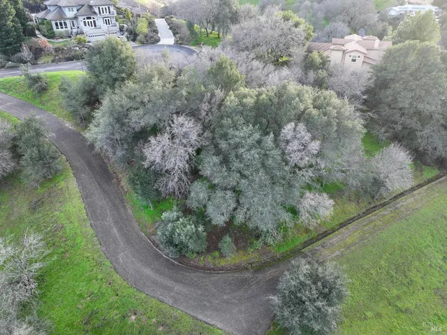 an aerial view of a house with a yard